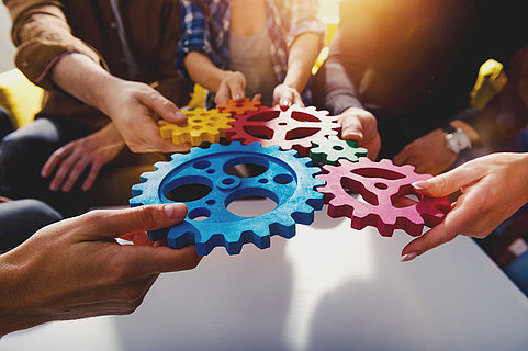 Business team connect pieces of gears like a teamwork and partners