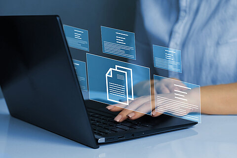 Businesswoman working on laptop with virtual screen