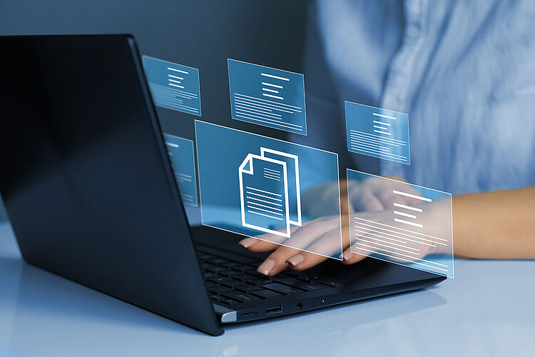 Businesswoman working on laptop with virtual screen