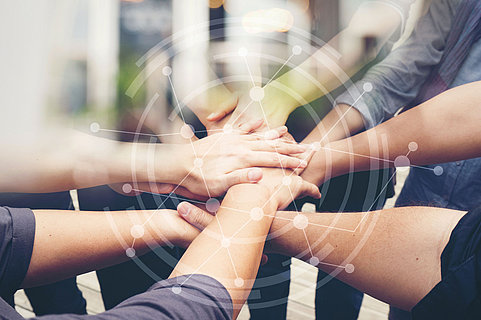 Close-up of the hands of people of different races, contracting trust and cooperation.