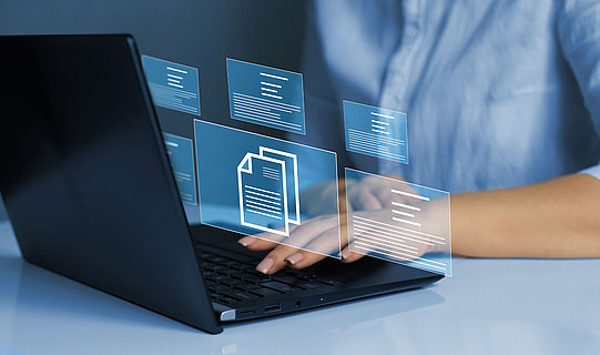 Businesswoman working on laptop with virtual screen