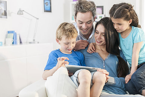 family playing together on a digital tablet